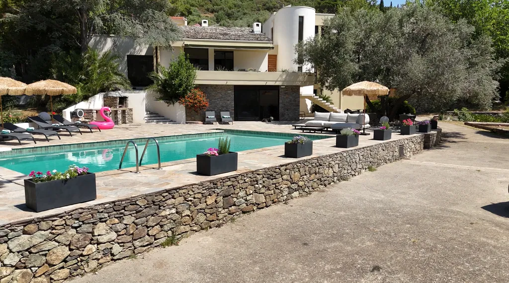 La piscine et le jardin de A Villa Rosa, terrasse et parasols, au début du Cap Corse